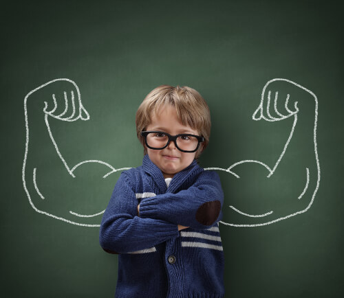 Child with a chalk board behind with an outline of large muscles